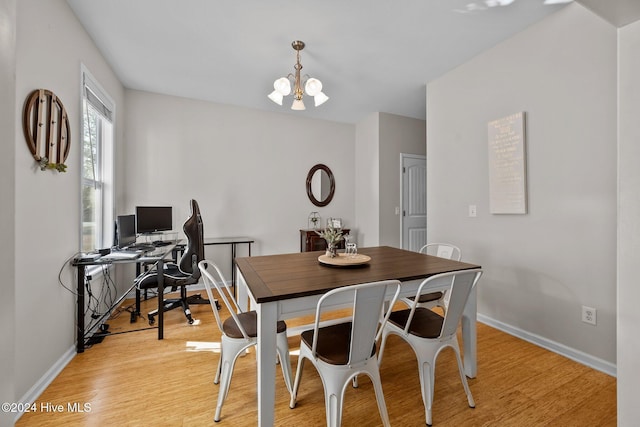 dining space featuring a chandelier and light hardwood / wood-style floors