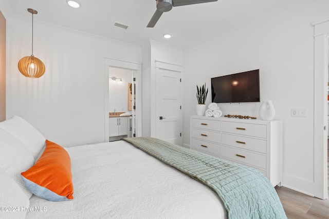 bedroom with ensuite bathroom, ceiling fan, wood-type flooring, and ornamental molding