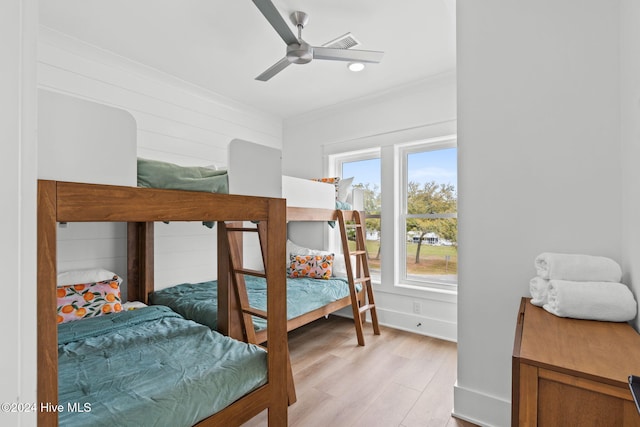 bedroom with ceiling fan, light hardwood / wood-style floors, and ornamental molding