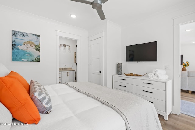 bedroom featuring crown molding, sink, ensuite bath, ceiling fan, and light hardwood / wood-style floors