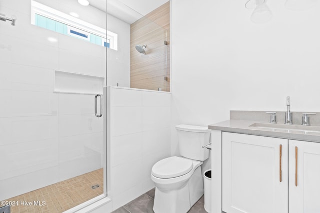 bathroom with vanity, toilet, an enclosed shower, and tile walls