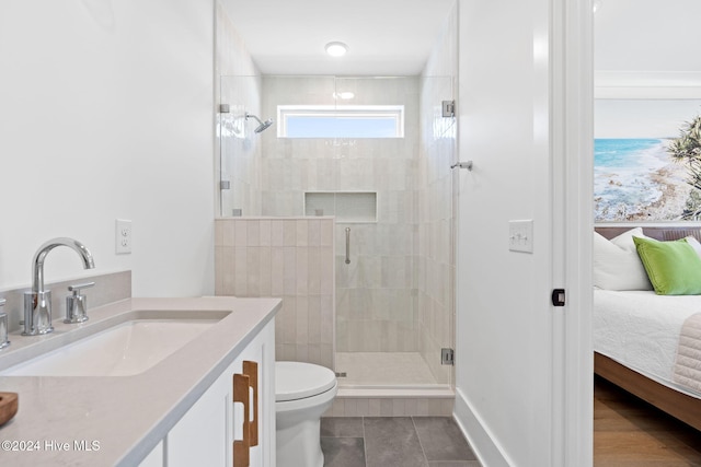 bathroom with tile patterned floors, toilet, vanity, and walk in shower