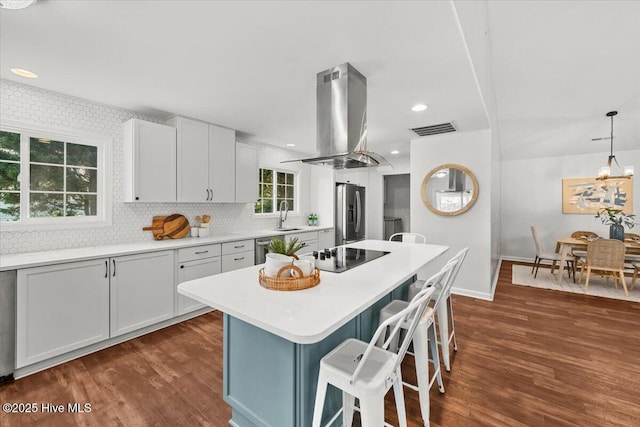 4 Emerald Ln, Pinehurst, NC 28374 - kitchen with stainless steel fridge, island range hood, black electric stovetop, a breakfast bar, and dark wood-type flooring
