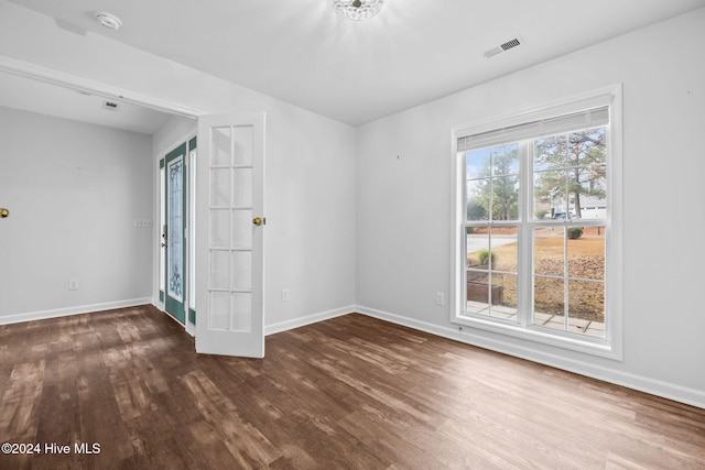 unfurnished room featuring dark wood-type flooring