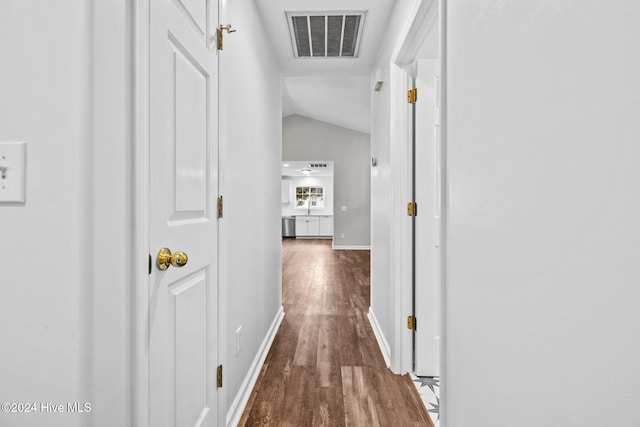 corridor featuring lofted ceiling and wood-type flooring