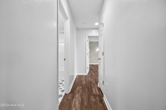 hallway with dark hardwood / wood-style floors