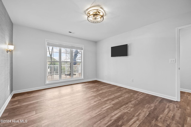 unfurnished room featuring hardwood / wood-style flooring