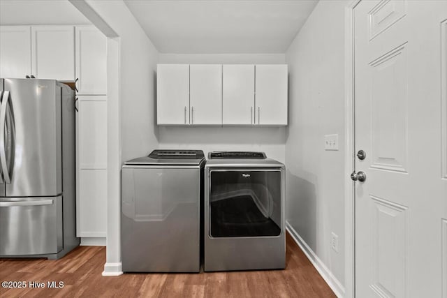 4 Emerald Ln, Pinehurst, NC 28374 - washroom featuring wood finished floors, washing machine and dryer, baseboards, and cabinet space