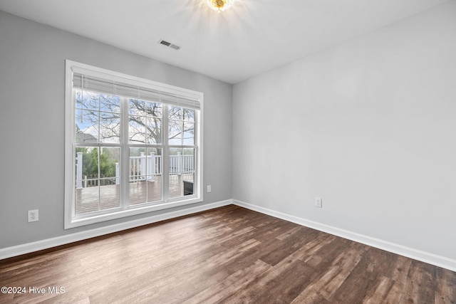 unfurnished room with wood-type flooring