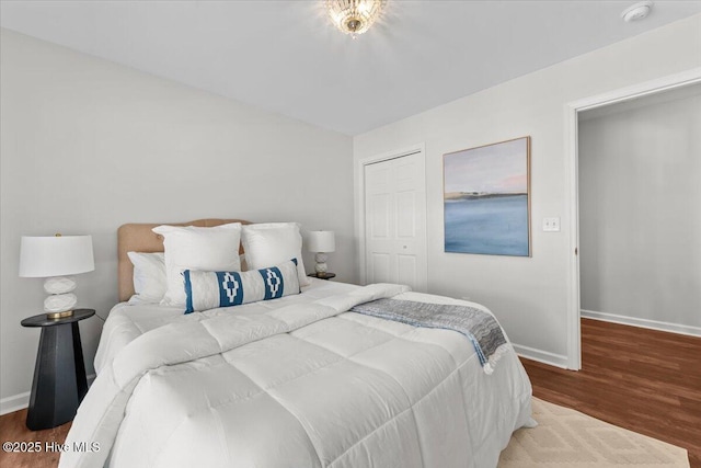 4 Emerald Ln, Pinehurst, NC 28374 - bedroom featuring baseboards, wood finished floors, lofted ceiling, and a closet