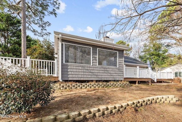 view of side of home featuring a wooden deck