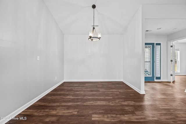 unfurnished dining area with an inviting chandelier and dark hardwood / wood-style floors