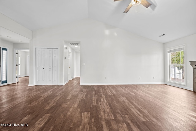 unfurnished living room featuring dark hardwood / wood-style flooring, vaulted ceiling, and ceiling fan