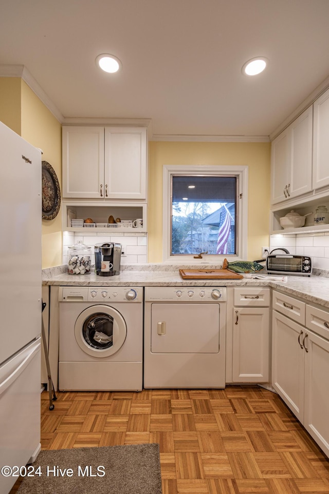 clothes washing area featuring recessed lighting, crown molding, separate washer and dryer, and laundry area