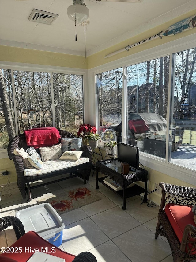 sunroom / solarium with visible vents and tile patterned floors