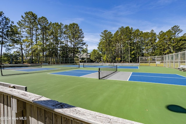 view of tennis court featuring basketball hoop