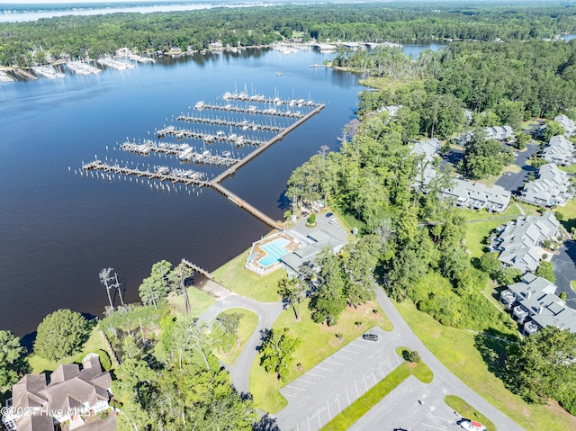 bird's eye view featuring a wooded view and a water view