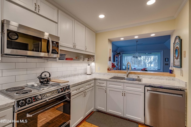 kitchen with sink, light parquet floors, hanging light fixtures, stainless steel appliances, and white cabinets