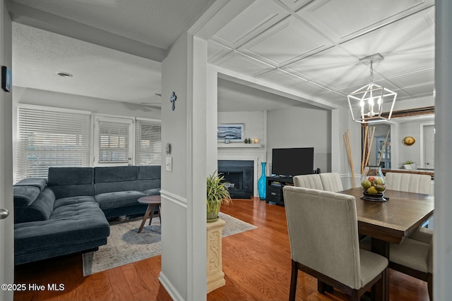 dining area with hardwood / wood-style floors and an inviting chandelier