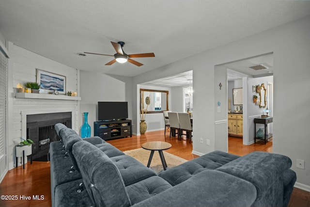 living room with hardwood / wood-style flooring and ceiling fan