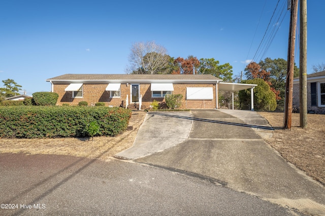 view of front of property featuring a carport