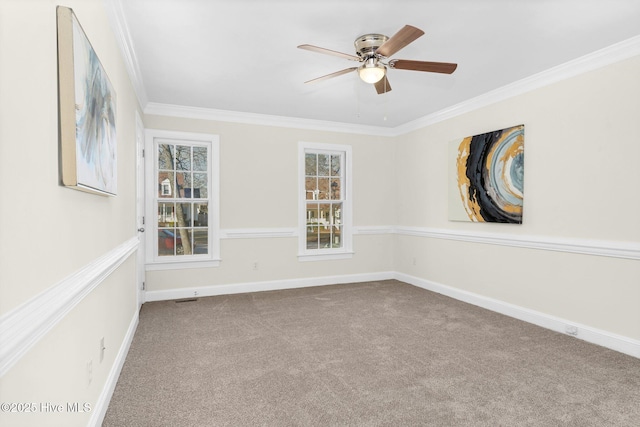 empty room featuring ceiling fan, ornamental molding, and light carpet