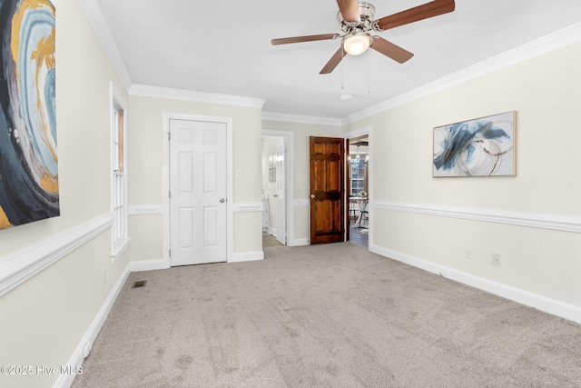 unfurnished bedroom with ceiling fan, ensuite bathroom, ornamental molding, and light carpet