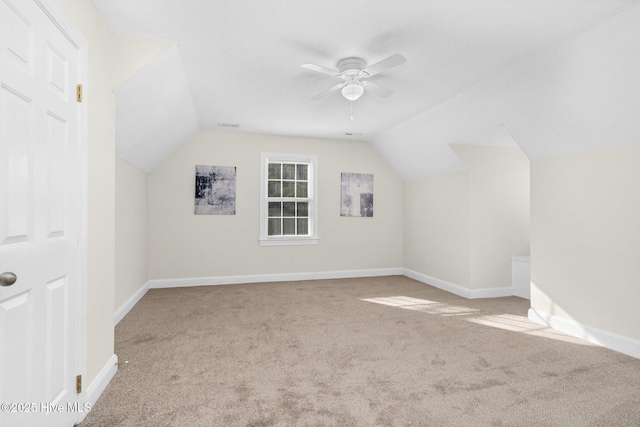 additional living space featuring ceiling fan, light carpet, and vaulted ceiling