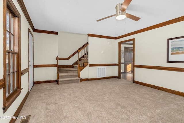 unfurnished room with light colored carpet, ceiling fan, and ornamental molding