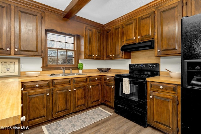 kitchen featuring sink, wood counters, beamed ceiling, light hardwood / wood-style floors, and black appliances