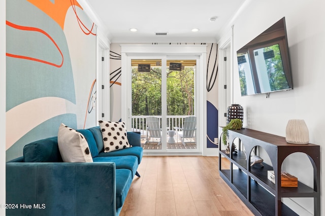 sitting room featuring light hardwood / wood-style floors and crown molding