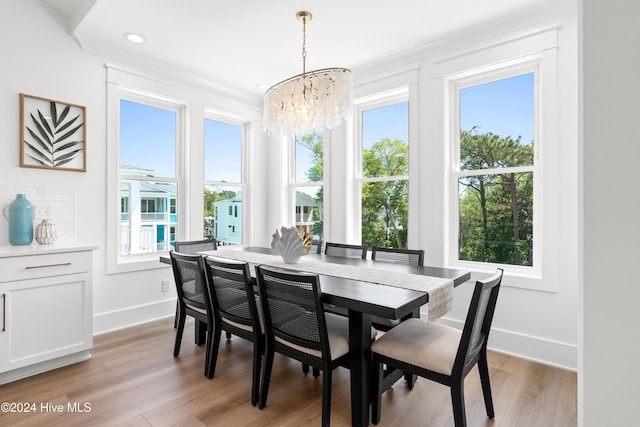 dining space featuring a wealth of natural light, light hardwood / wood-style flooring, and a chandelier