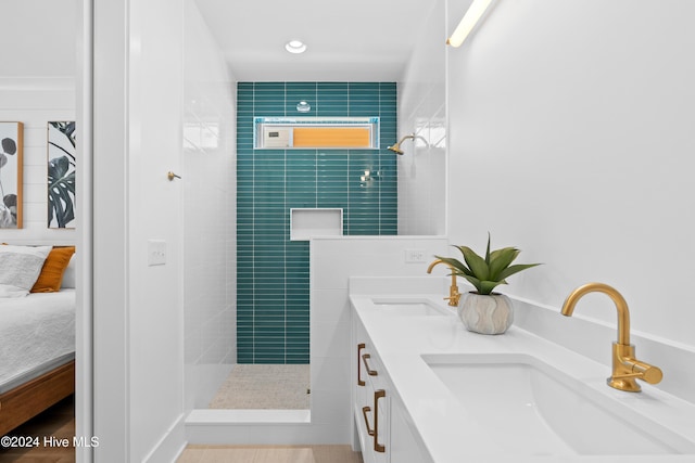 bathroom with vanity and tiled shower