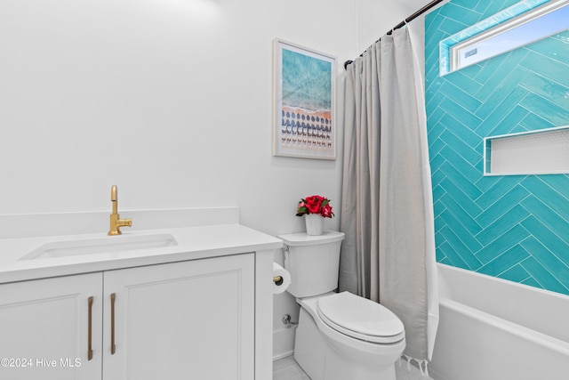 full bathroom featuring vanity, shower / bath combination with curtain, and toilet