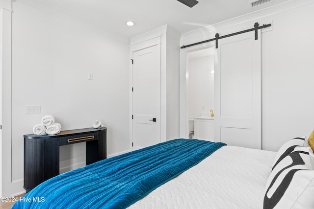 bedroom with a barn door and a closet