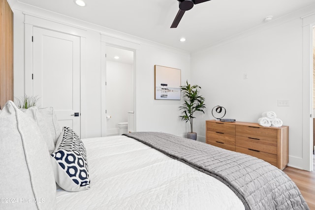 bedroom with ceiling fan, ornamental molding, light hardwood / wood-style flooring, and ensuite bath