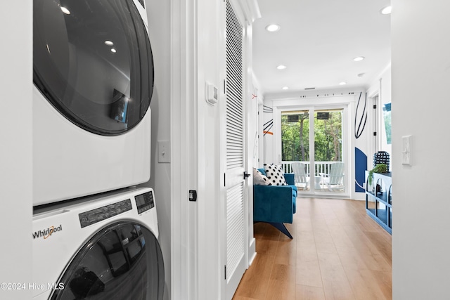 laundry area featuring light wood-type flooring and stacked washing maching and dryer