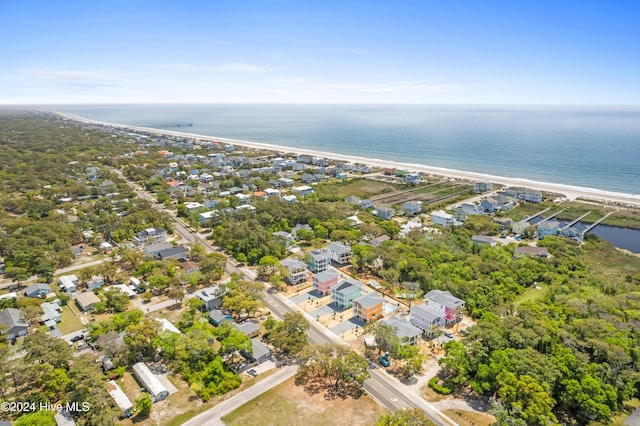 birds eye view of property featuring a water view and a beach view