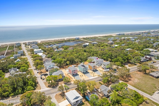 birds eye view of property with a water view and a view of the beach