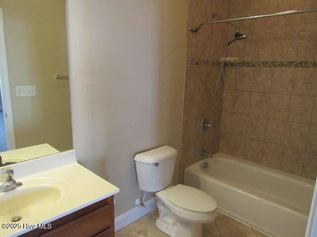 full bath with baseboards, toilet, tile patterned floors,  shower combination, and vanity