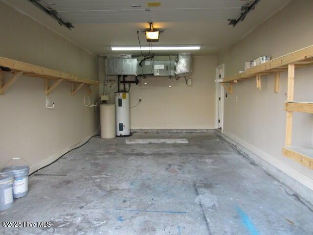 garage featuring a garage door opener and water heater