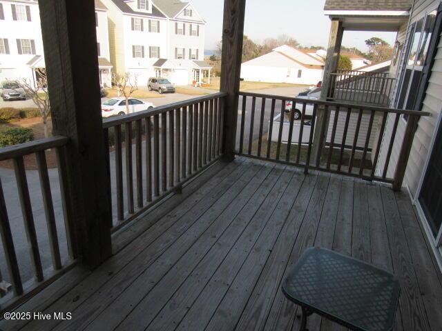 wooden terrace featuring a residential view