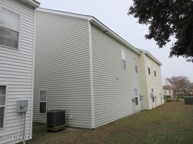 view of home's exterior featuring a yard and cooling unit