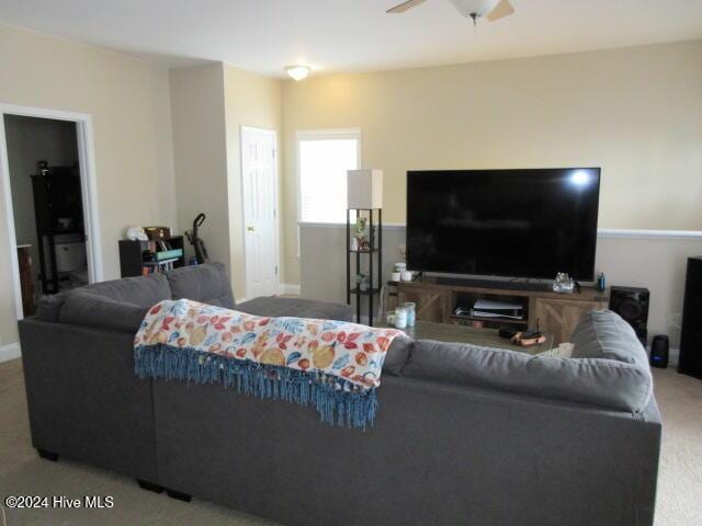 living room featuring carpet and ceiling fan