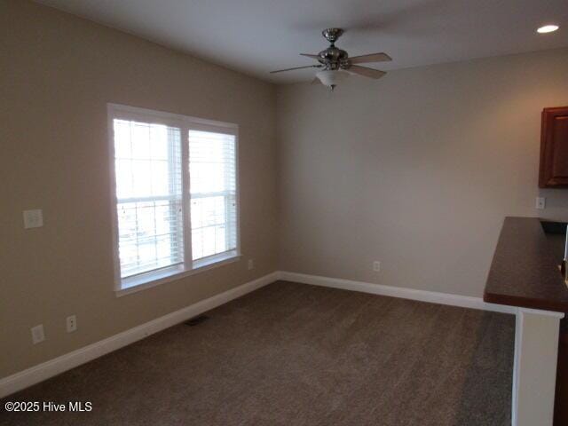 unfurnished dining area with carpet floors, baseboards, a ceiling fan, and recessed lighting