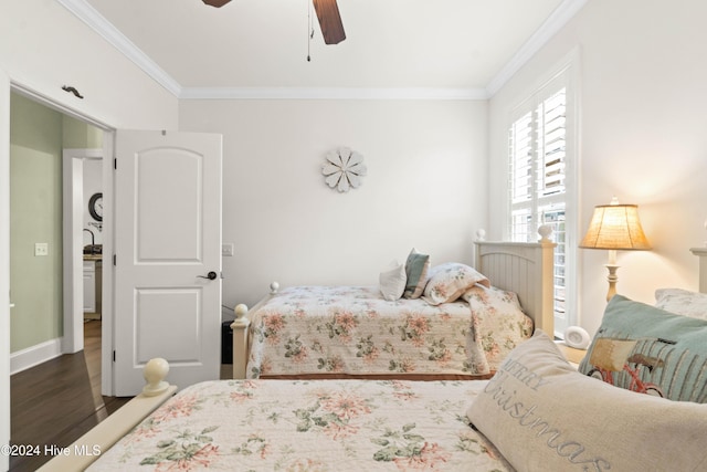 bedroom with ornamental molding, dark hardwood / wood-style floors, and ceiling fan