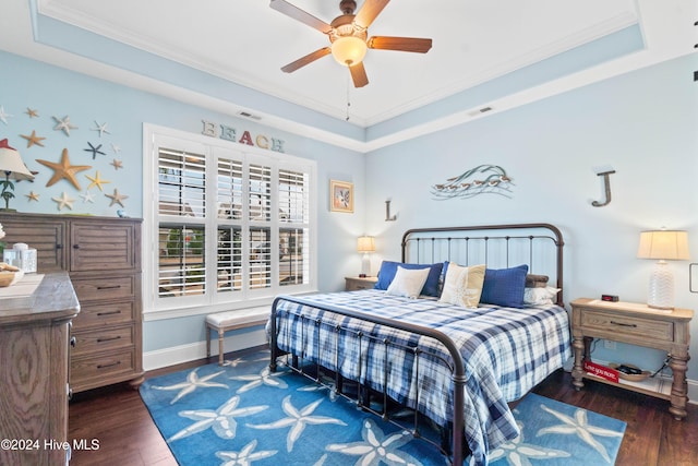 bedroom with dark wood-type flooring, ceiling fan, crown molding, and a raised ceiling