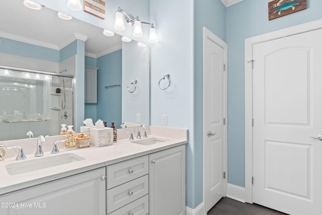 bathroom with an enclosed shower, vanity, and ornamental molding