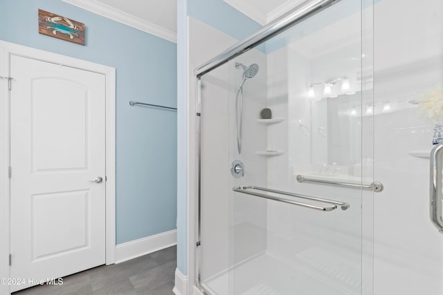 bathroom with crown molding, baseboards, and a stall shower