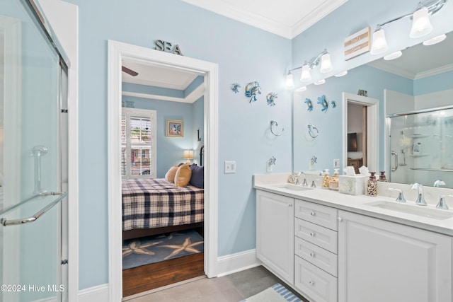 bathroom with vanity, crown molding, and a shower with shower door